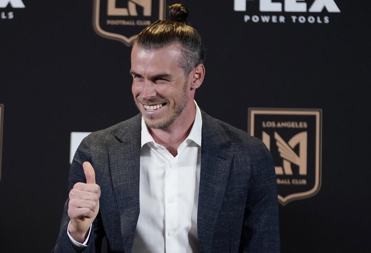Gareth Bale gives a thumbs up for the cameras during his introductory news conference for LAFC.