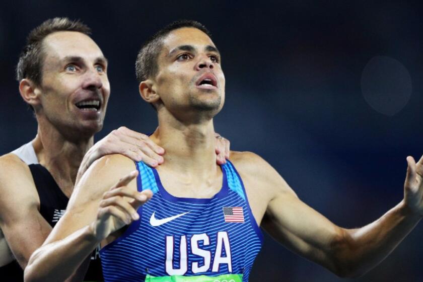 Matthew Centrowitz of the United States reacts with Nicholas Willis of New Zealand after winning the gold medal in the men's 1500-meter final.