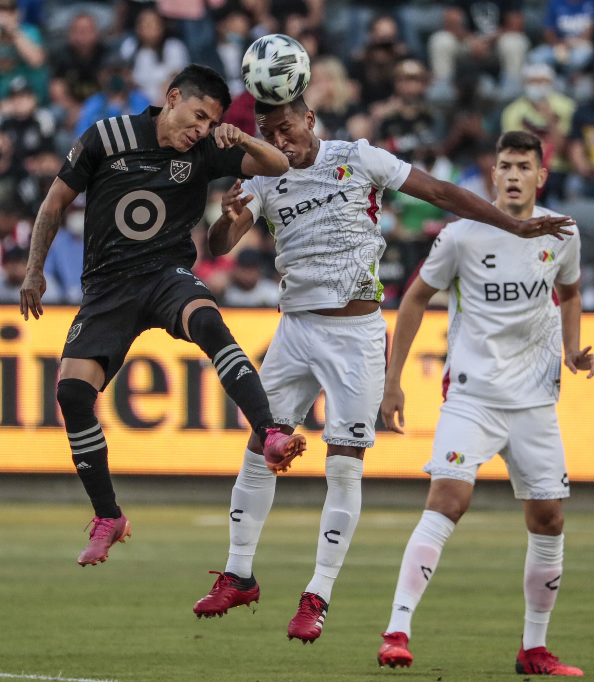 Liga MX midfielder Pedro Aquino, right, and MLS forward Raul Ruidiaz compete for the ball