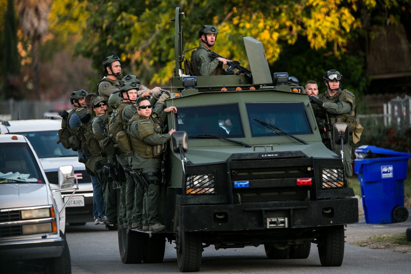 Sheriff's department SWAT members deploy on Richardson Street in San Bernardino on Wednesday.