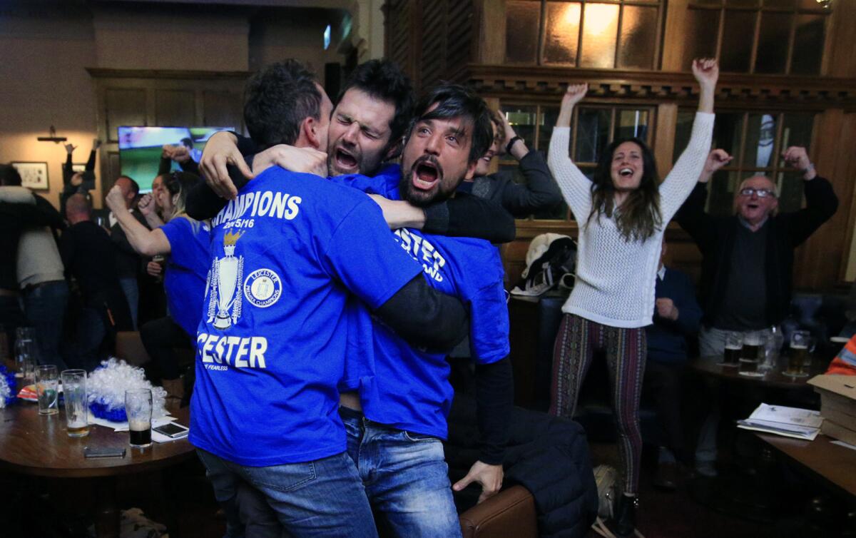 Leicester City soccer fans react in Hogarths public house in Leicester, central England, on Monday after Chelsea beat Tottenham in their English Premier League soccer match. The match ended in a tie, resulting in Leicester City winning the Premier League championship.