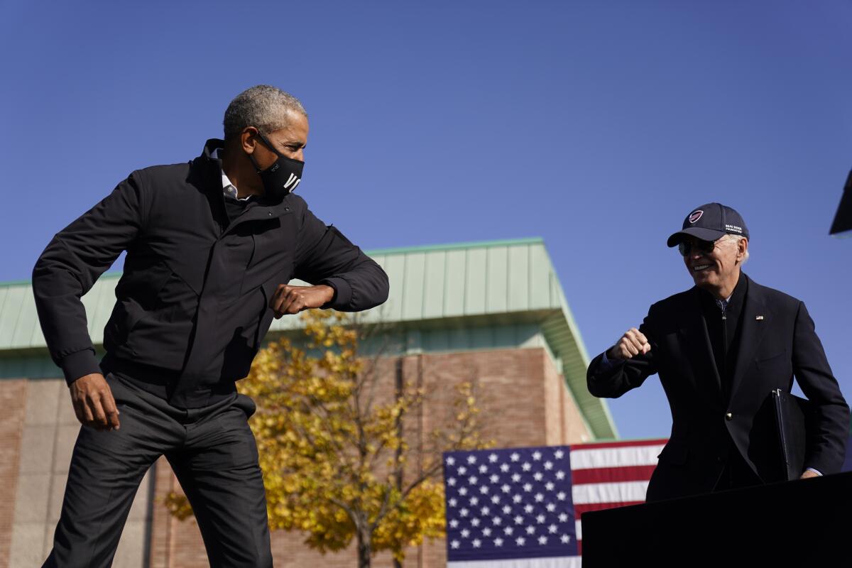Former President Obama helps former Vice President Joe Biden campaign for president in Flint, Mich., on Oct. 31.