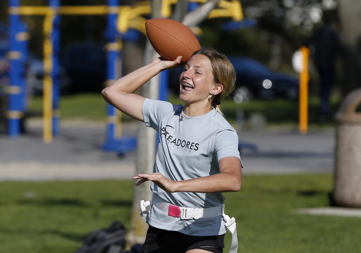 Quarterback Scarlett Guyser of Seals Football Club throws a pass during practice at Mariners Park on Wednesday.