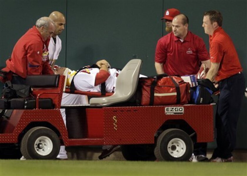 St. Louis Cardinals center fielder Rick Ankiel is taken off the field on a cart after catching a ball hit by Philadelphia Phillies' Pedro Feliz then hitting the outfield wall during the eighth inning of a baseball game Monday, May 4, 2009, in St. Louis. (AP Photo/Jeff Roberson)