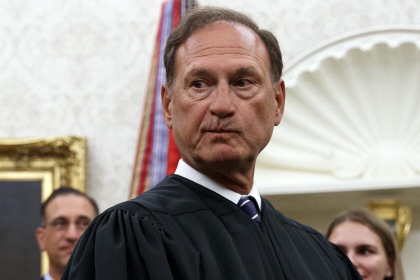 FILE - Supreme Court Justice Samuel Alito pauses after swearing in Mark Esper as Secretary of Defense during a ceremony with President Donald Trump in the Oval Office at the White House in Washington, July 23, 2019. A second flag of a type carried by rioters during the attack on the U.S. Capitol on Jan. 6, 2021, was displayed outside a house owned by Alito according to a report published May 22, 2024, by The New York Times. (AP Photo/Carolyn Kaster, File)