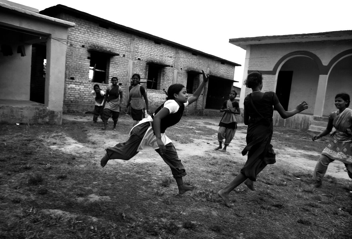 The school girls play a game of kabaddi during recess.