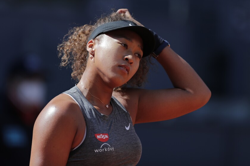Naomi Osaka of Japan reacts during her match against Karolina Muchova of the Czech Republic during their match at the Madrid Open tennis tournament in Madrid, Spain, Sunday, May 2, 2021. (AP Photo/Paul White)