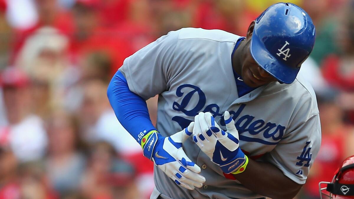 Dodgers right fielder Yasiel Puig reacts after being struck in the left hand with a pitch during Saturday's loss to the St. Louis Cardinals.