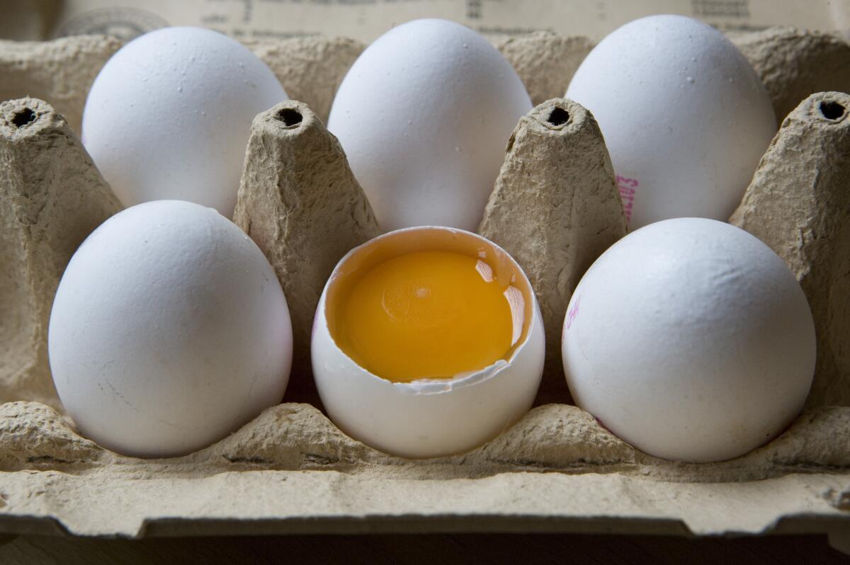 Raw egg in an egg carton.