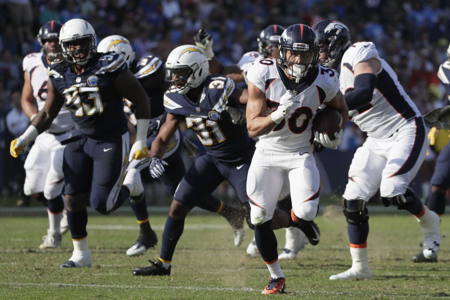 Denver Broncos running back Phillip Lindsay speeds past the Chargers defense for a long first half touchdown run at Stubhub Center on Sunday.