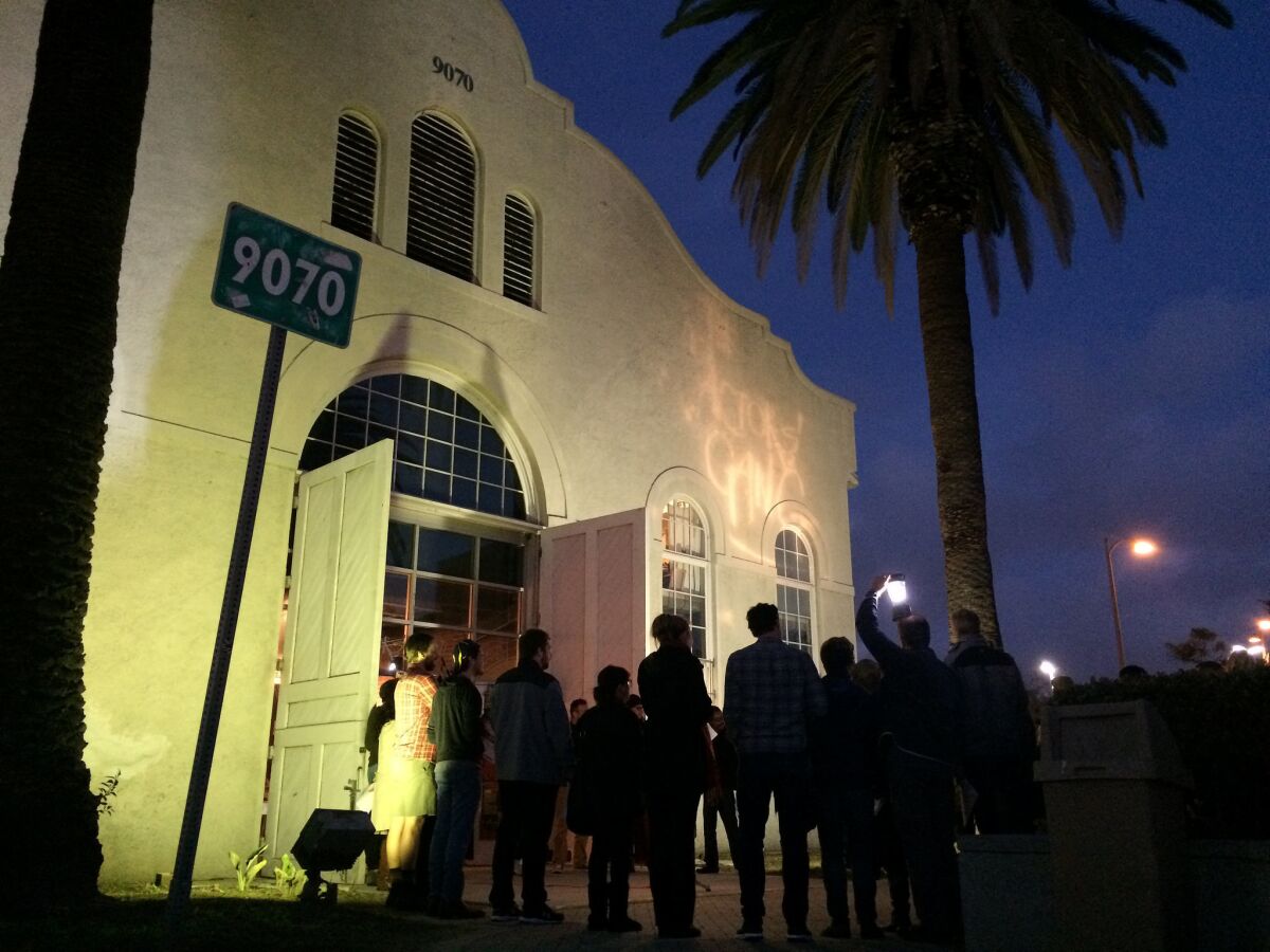 Members of the Actors' Gang theater in Culver City gather before their space on the eve of the presidential inauguration to turn on a light as a symbol of tolerance.