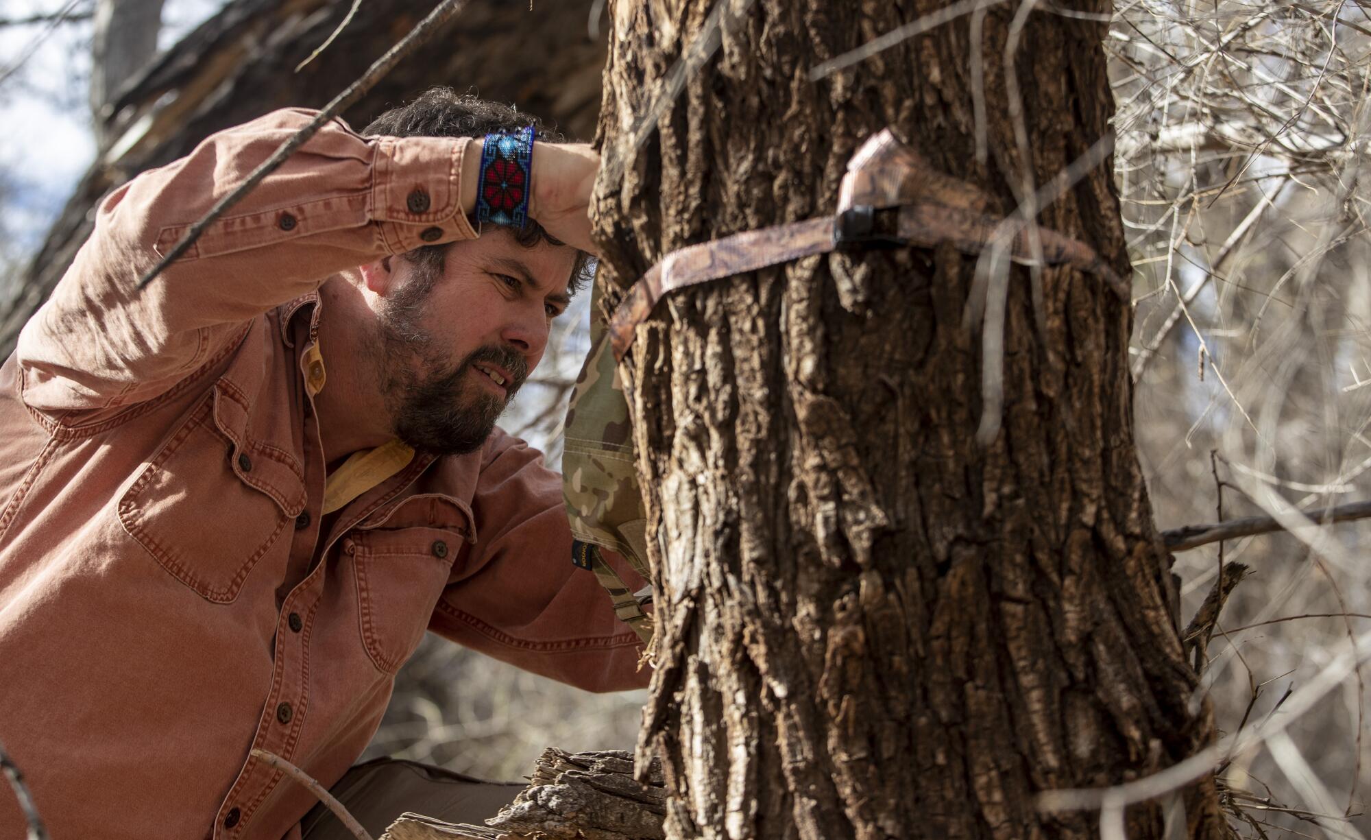 Myles Traphagen, checks camera traps in the San Bernardino National Wildlife Refuge.