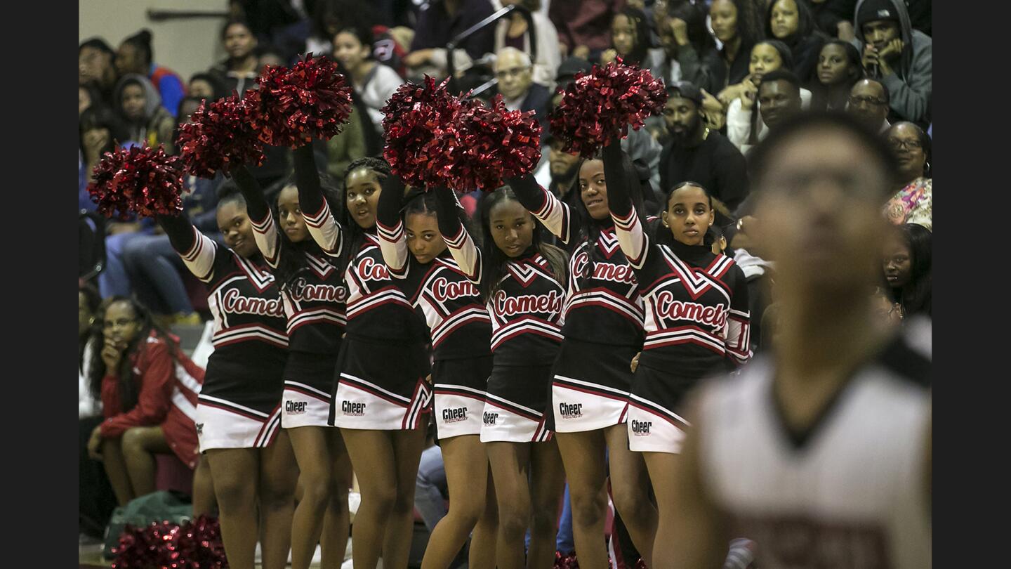 Cheerleaders look on as the junior varsity Westchester Comets play the Fairfax Lions at Westchester High School.