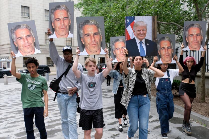 A group of young protesters holds pictures of Jeffrey Epstein and Donald Trump outside the Federal Court in downtown Manhattan on July 8, 2019, where Jeffrey Epstein the wealth money manager who was arrested on Saturday was being charged with sex trafficking of minors and conspiracy to commit sex trafficking of minors. (Luiz C. Ribeiro/New York Daily News/TNS) ** OUTS - ELSENT, FPG, TCN - OUTS **