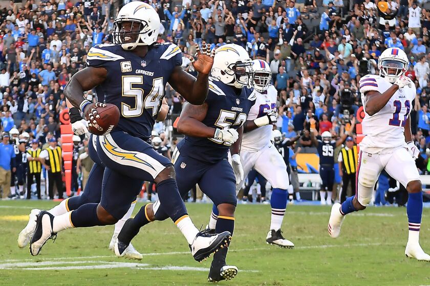 Chargers defensive end Melvin Ingram picks up a fumble by Bills quarterback Tyrod Taylor and scores a touchdown in the 3rd quarter.