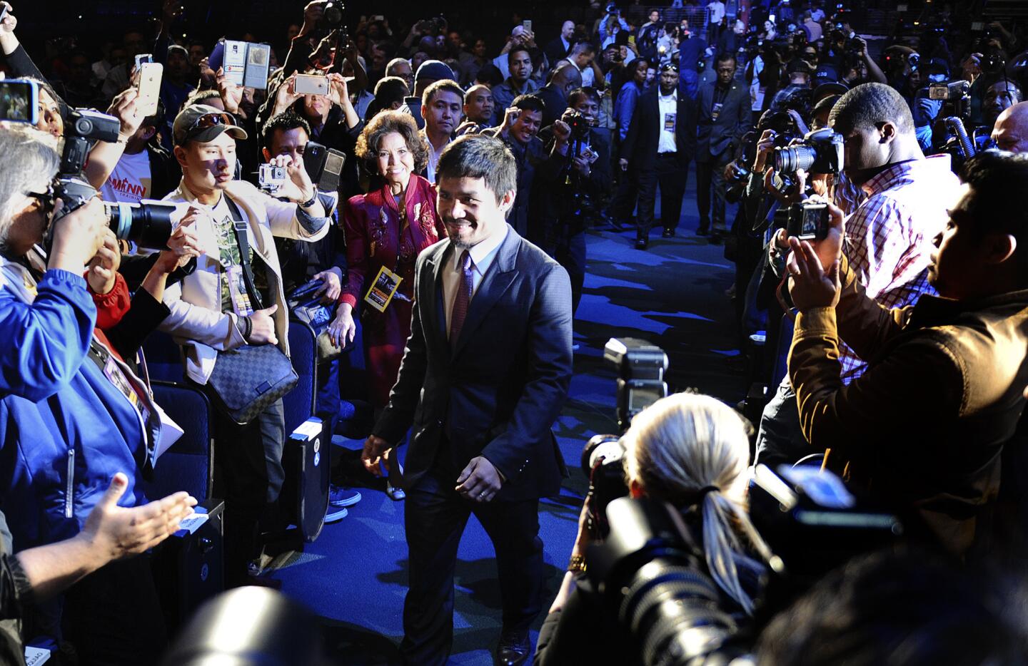 Boxer Manny Pacquiao is introduced as he walks into the Nokia Theatre on Wednesday before a news conference.