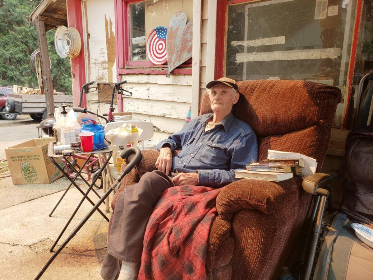Gordon "Oly" Olson sits in a recliner on his porch with a cane nearby