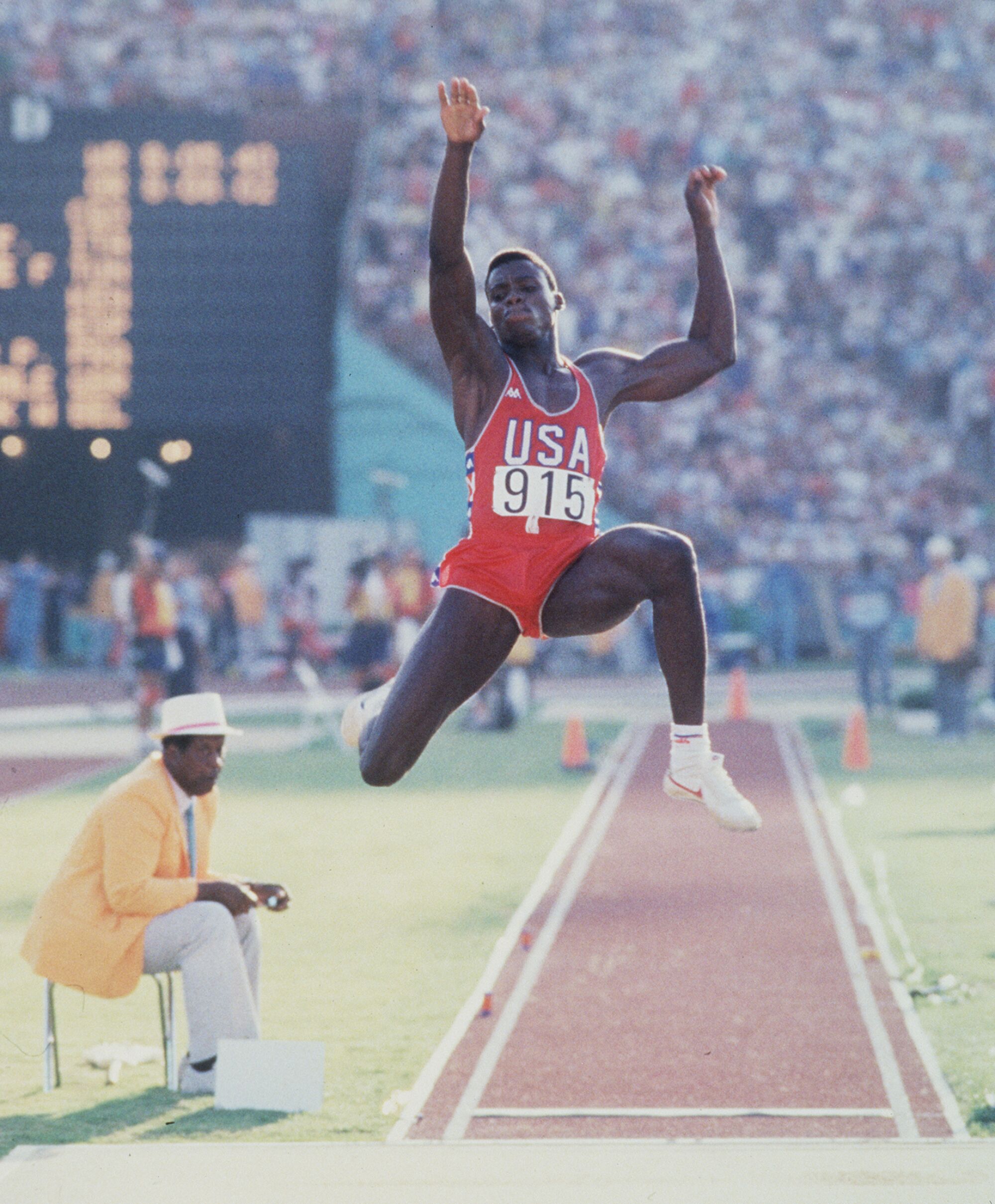  Carl Lewis makes his first jump in the finals of the long jump at the Olympic Games in Los Angeles.