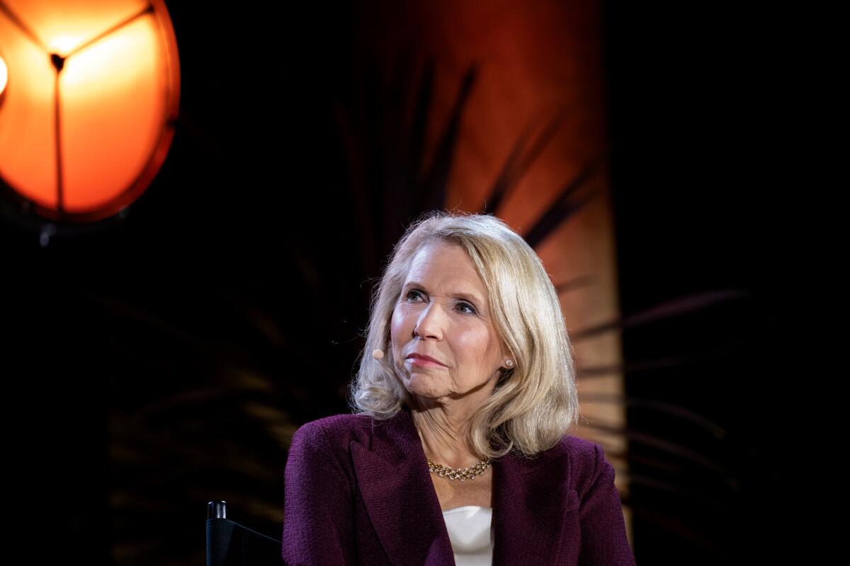 Shari Redstone, a blond woman looking up to one side under a stage light