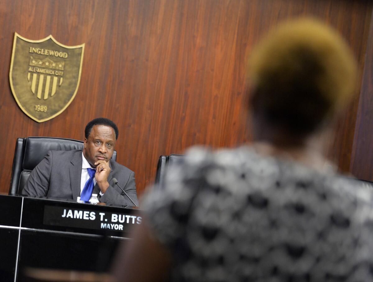 Inglewood Mayor James T. Butts listens to a constituent during a City council meeting in March. A recent vote to change the time of all council meetings has drawn criticism from the public.