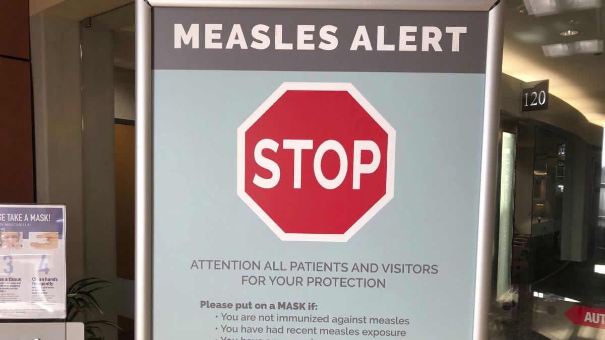 A sign warning patients and visitors of a measles outbreak on Jan. 30.