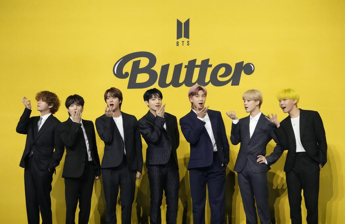 FILE- Members of South Korean K-pop band BTS, V, SUGA, JIN, Jung Kook, RM, Jimin, and j-hope from left to right, pose for photographers ahead of a press conference to introduce their new single "Butter" in Seoul, South Korea, May 21, 2021. The members of K-pop band BTS will serve their mandatory military duties under South Korean law, their management company said Monday, Oct. 17, 2022, effectively ending a debate on exempting them because of their artistic accomplishments. (AP Photo/Lee Jin-man, File)