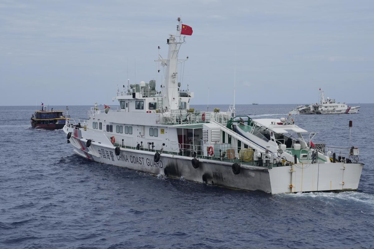A Chinese coast guard ship tries to block the way of a Philippine supply boat.