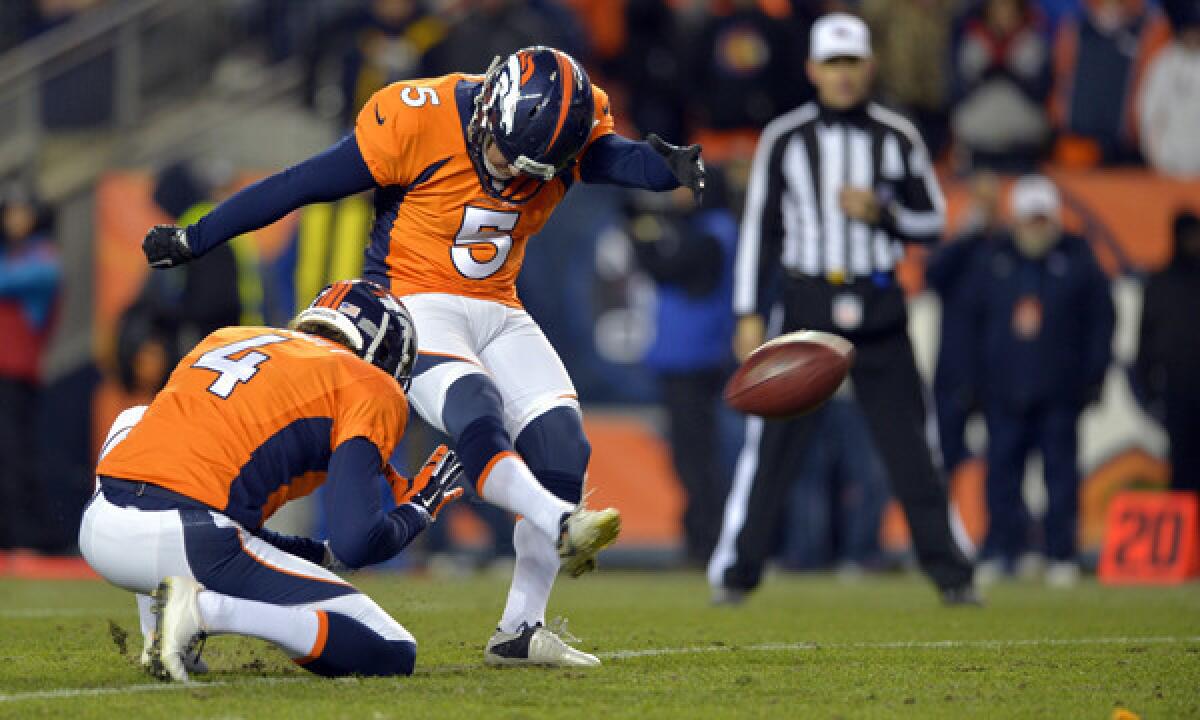 Denver Broncos kicker Matt Prater kicks an extra point as teammate Britton Colquitt during an AFC divisional playoff game against the San Diego Chargers in January. The NFL's competition committee will present a proposal to move extra-point attempts to the 25-yard line at this week's team owners' meetings.