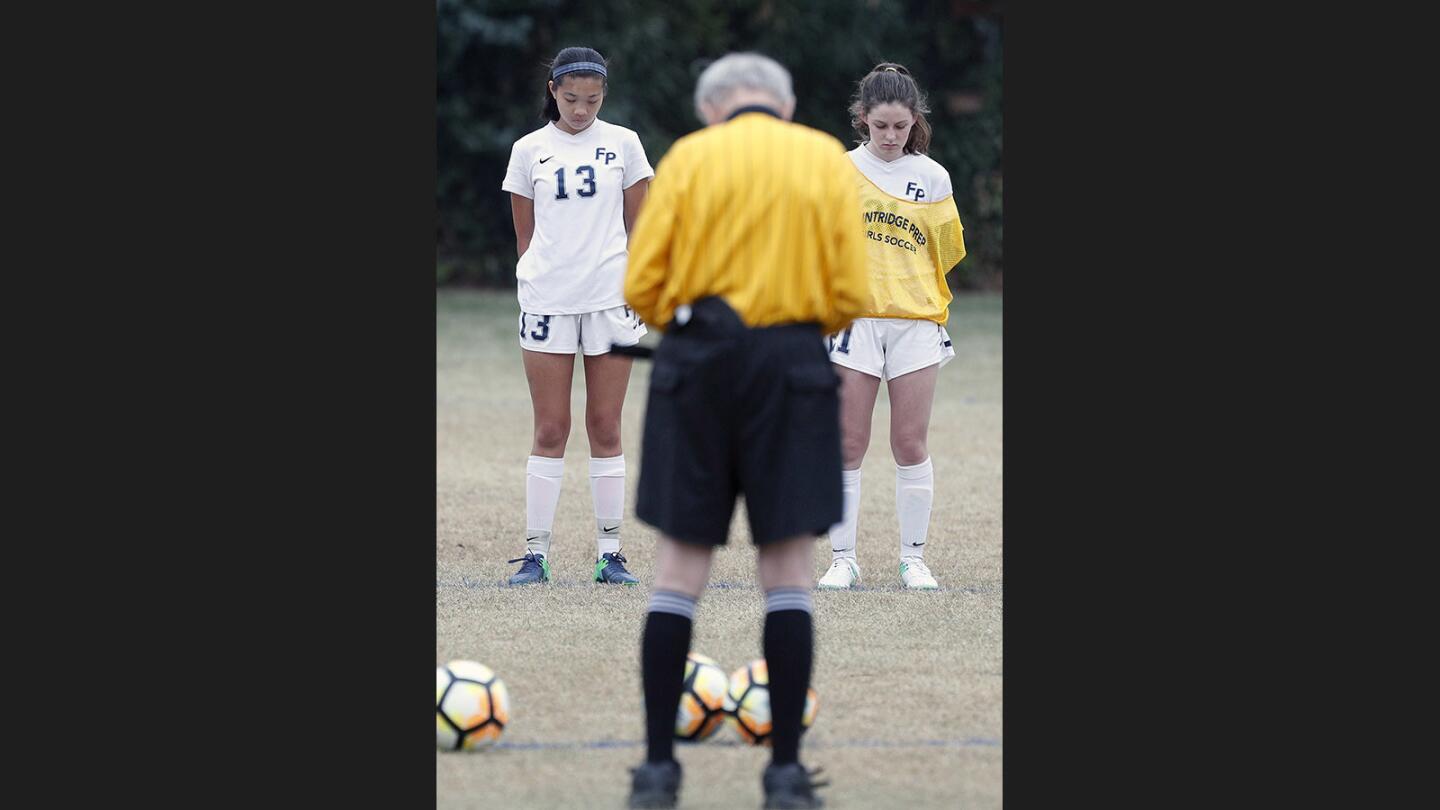 Prep's Mel Ng and Kate Huntley, along with the rest of their team, the Polytechnic team, coaches and referees, take a moment of silence for a soccer club team teammate who committed suicide recently. The moment was before the start of a Prep League girls' soccer game at Flintridge Preparatory School on Tuesday, January 16, 2018. Flintridge Prep won the rival game 6-0.