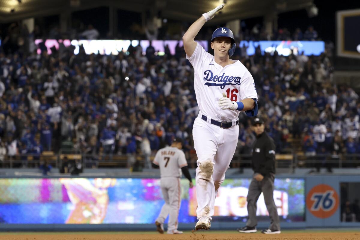 LOS ANGELES, CA - JULY 21: Los Angeles Dodgers catcher Will Smith (16)  throws to first base during the MLB game between the San Francisco Giants  and the Los Angeles Dodgers on