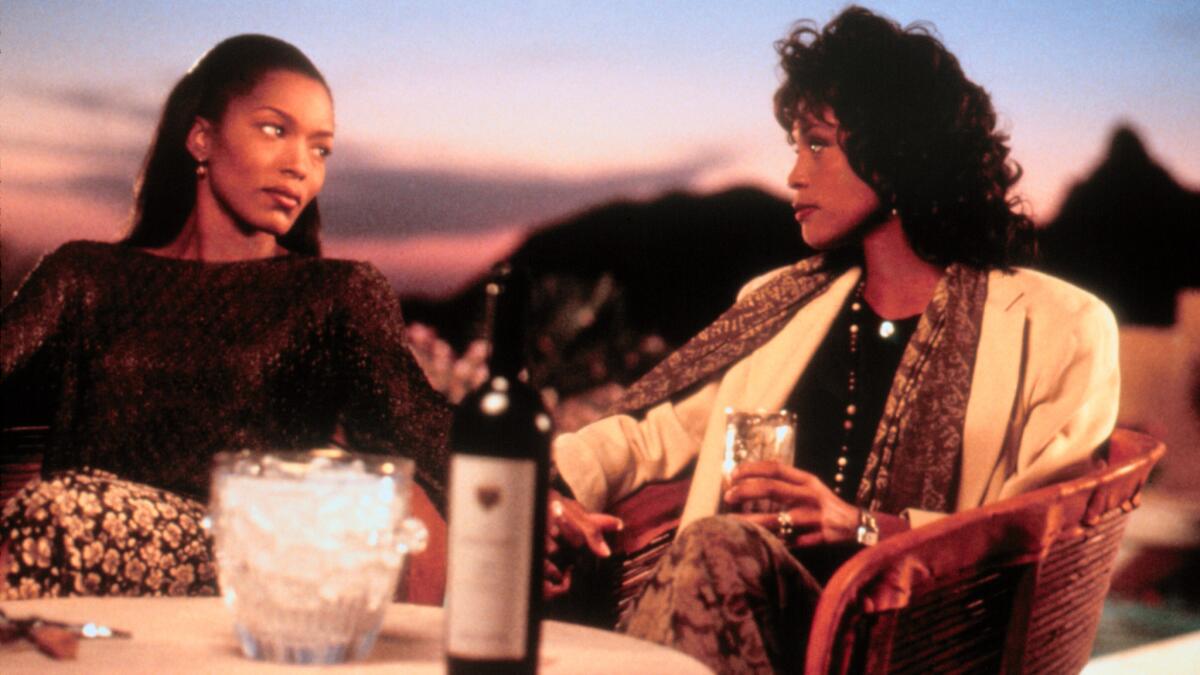 Whitney Houston and Angela Bassett looking at each other in "Waiting to Exhale"