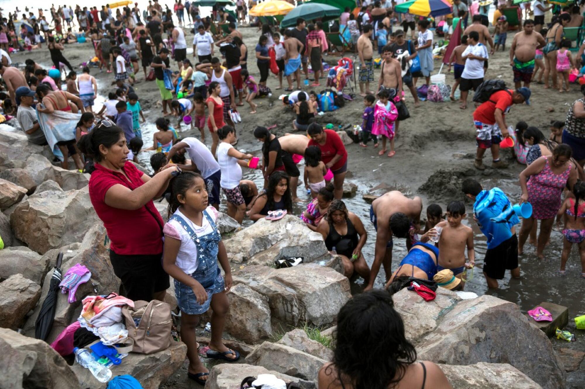 Beachgoers at the Lima beach on Feb. 23.