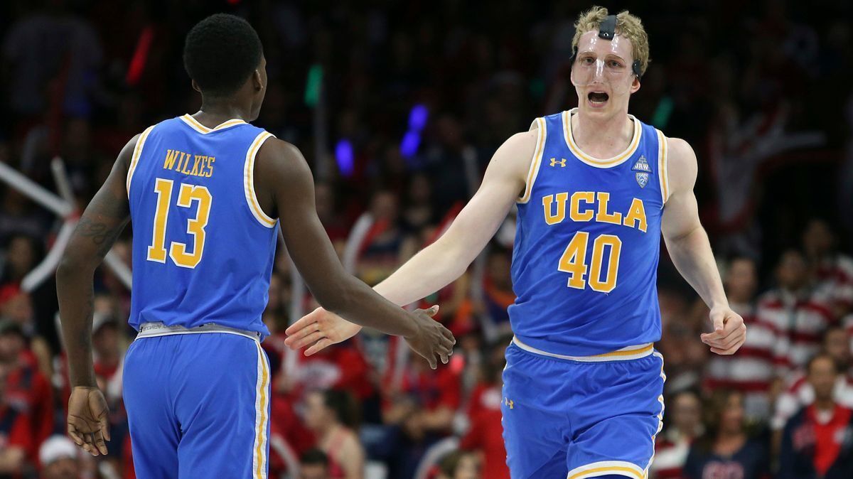 UCLA center Thomas Welsh (40) reacts with teammate Kris Wilkes after a dunk during the second half against Arizona on Feb. 8. UCLA defeated Arizona 82-74.