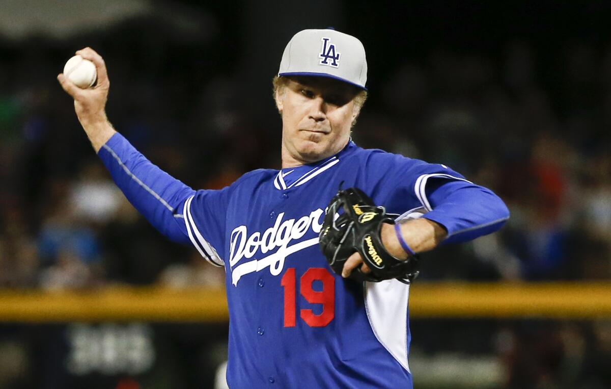 Actor Will Ferrell delivers a pitch for the Dodgers during a spring training game in Peoria, Ariz.