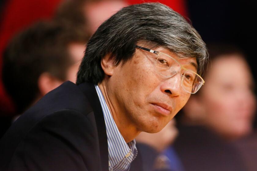 Dr. Patrick Soon-Shiong sits courtside as the Los Angeles Lakers play against the Utah Jazz during the second half of an NBA basketball game in Los Angeles, Tuesday, Feb. 11, 2014. The Jazz won 96-79. (AP Photo/Danny Moloshok)