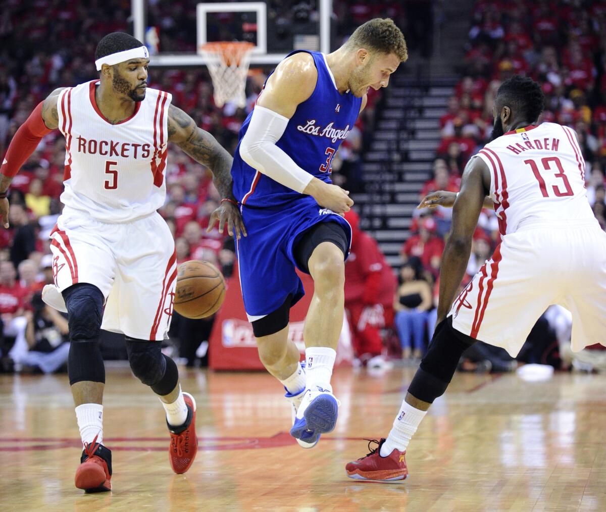 Clippers forward Blake Griffin has the ball knocked away by Rockets guard James Harden (13) while bringing it up court in Game 2.