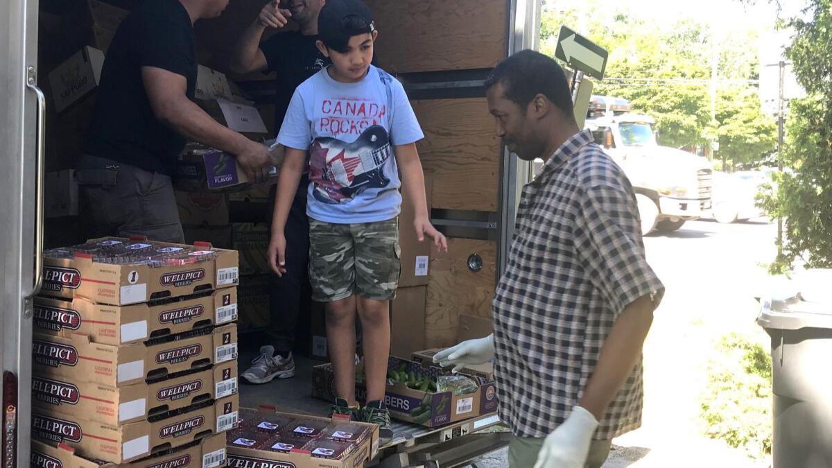 At CACI, a nonprofit organization in Montreal that helps immigrants, volunteers unload supplies for a food bank that serves recent asylum seekers.