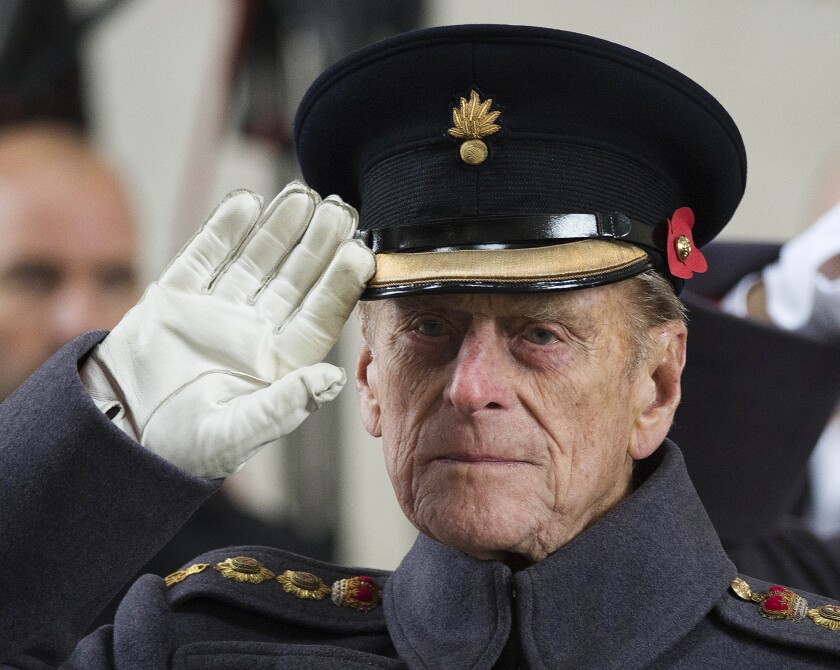 FILE - In this file photo dated Monday, Nov. 11, 2013, Britain's Prince Philip salutes during a special Armistice Day ceremony under the Menin Gate in Ypres, Belgium. The Duke of Edinburgh attended a special Armistice Day ceremony on Monday to oversee the handover of 70 sandbags of soil from Flanders fields. The sandbags, collected by Belgian and British schoolchildren from Commonwealth cemeteries in Belgium, were handed over to the King's Troop Royal Horse Artillery and will be taken to London and placed in the Flanders Fields Memorial Garden at the Wellington Barracks. When Elizabeth became queen at the age of 25 in 1952, Philip gave up his naval career and dedicated himself to supporting her and the monarchy. Prince Philip who died Friday April 9, 2021, aged 99, lived through a tumultuous century of war and upheavals. (AP Photo/Paul Edwards, FILE)