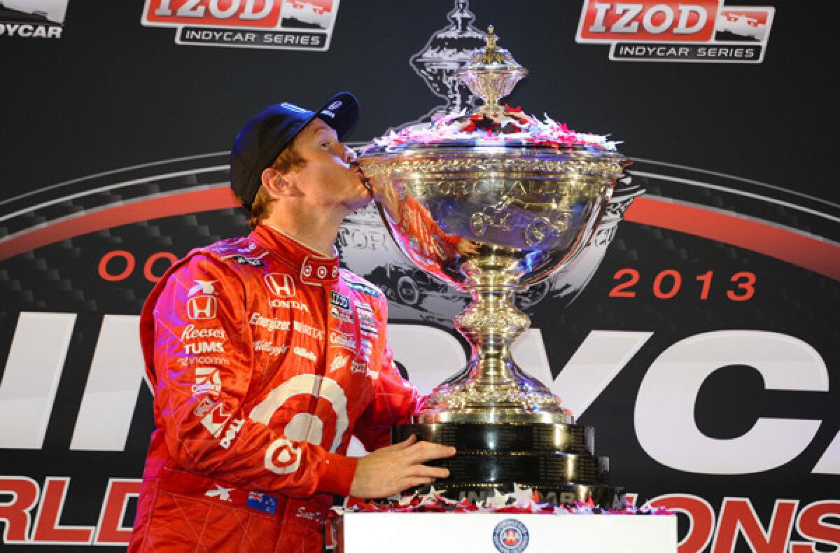 Scott Dixon gives the Astor Cup a kiss after winning the IndyCar Series on Saturday night with a fifth-place finish at Fontana.