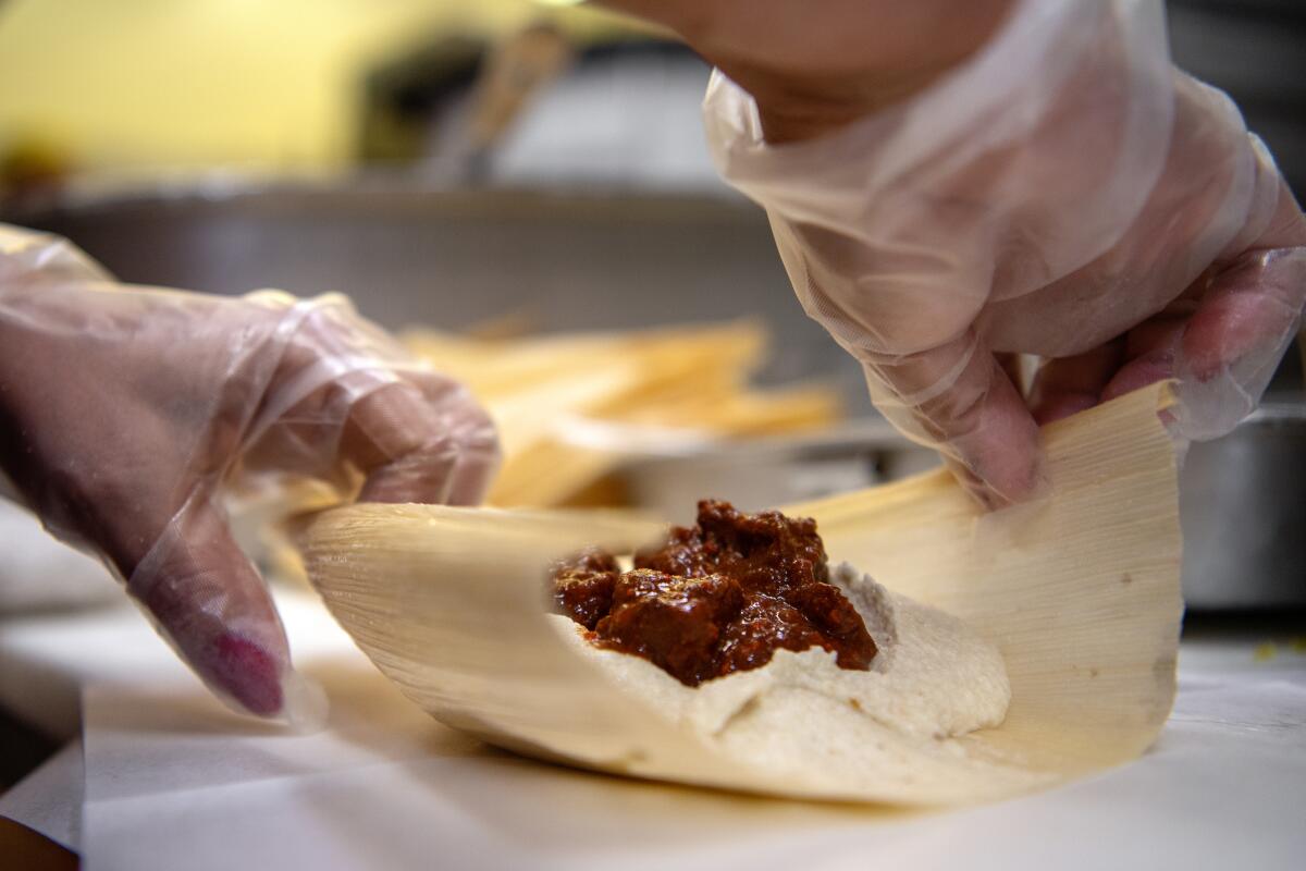 Beef tamales are prepared inside the kitchen of Tito's Tacos.