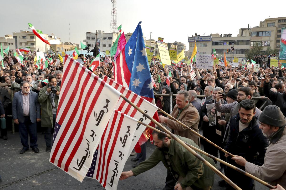 Demonstrators burn representations of the U.S. flag  in Tehran.