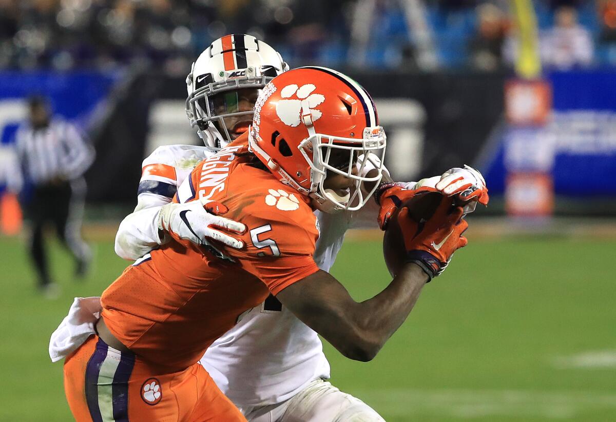Clemson's Tee Higgins (5) makes a catch against Virginia's Nick Grant during the ACC championship game Dec. 7, 2019.