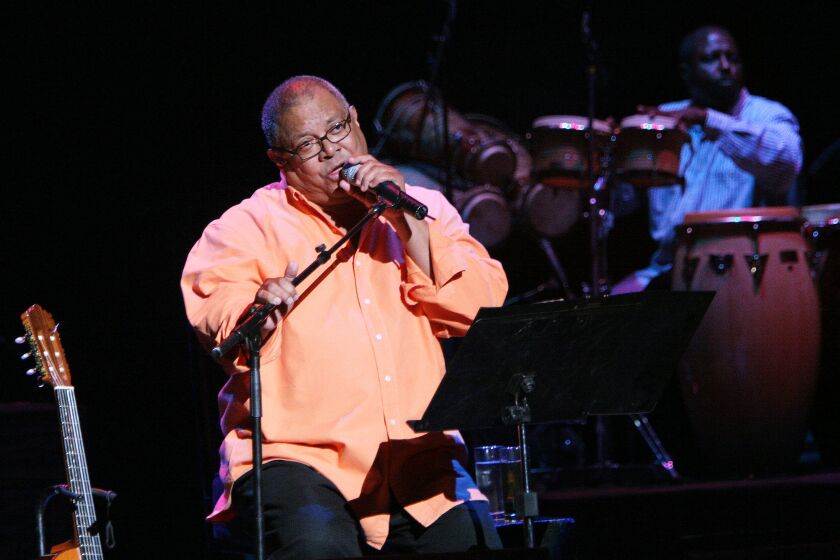 FILE- In this May 27, 2006, file photo, Cuban singer and composer Pablo Milanes performs during a concert at the National Theater in Santo Domingo. Documents obtained by The Associated Press show a U.S. agency decided to infiltrate an arts and music festival put on by Milanes’ family, part of a plan to recruit unwitting rappers to spark a youth movement against the government. (AP Photo/Ramon Espinosa, File)
