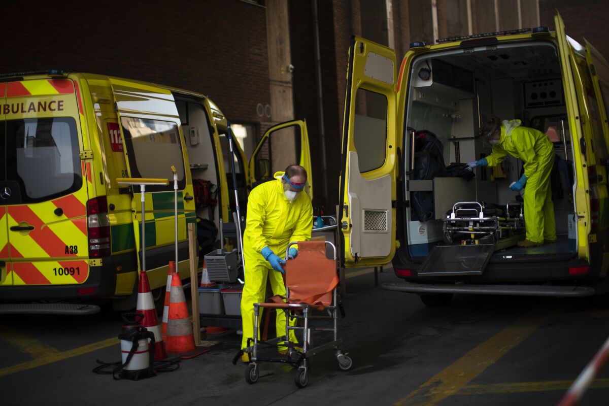 Firefighters disinfect ambulances used to transfer coronavirus patients in Brussels.