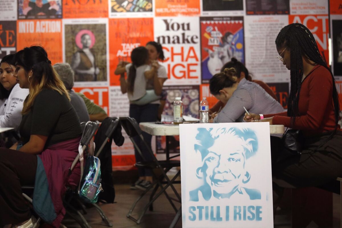 Artists and citizens at the Into Action event made posters and signs to carry in Saturday's Women's March.