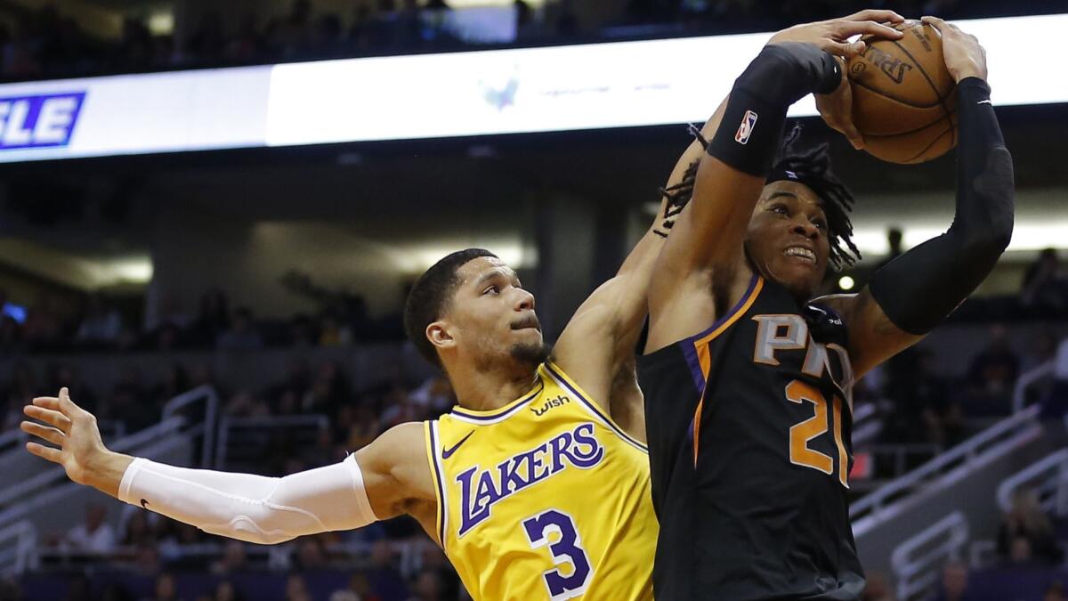 Lakers guard Josh Hart blocks a shot by Phoenix's Richaun Holmes on March 2.
