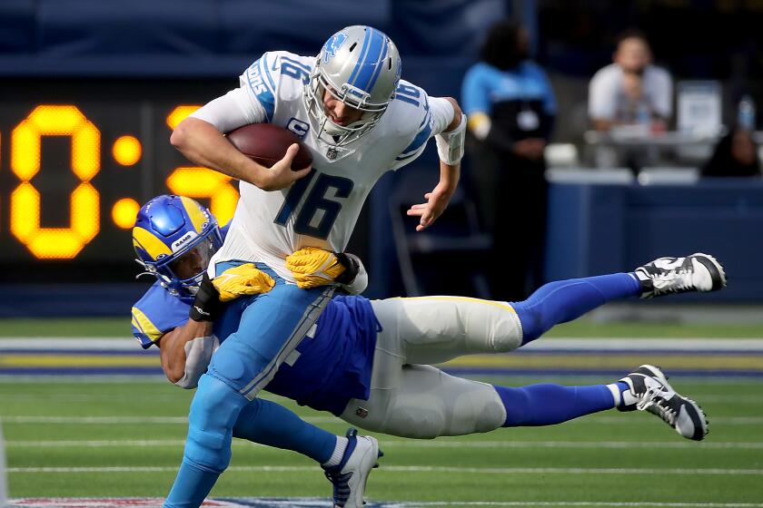 INGLEWOOD, CALIF. - OCT. 24, 2021. Lions quarterback Jared Goff is brought down.