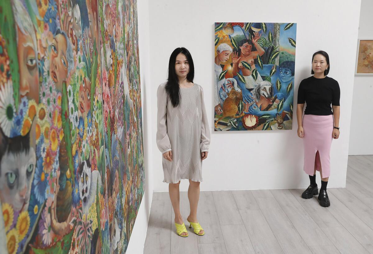 Co-founders Lorraine Han and Dan Yang stand inside Unveil Gallery.