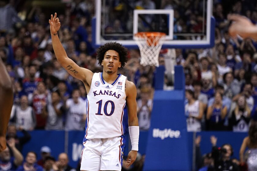 Kansas forward Jalen Wilson celebrates after making a basket during the first half of an NCAA college basketball game against Seton Hall Thursday, Dec. 1, 2022, in Lawrence, Kan. (AP Photo/Charlie Riedel)