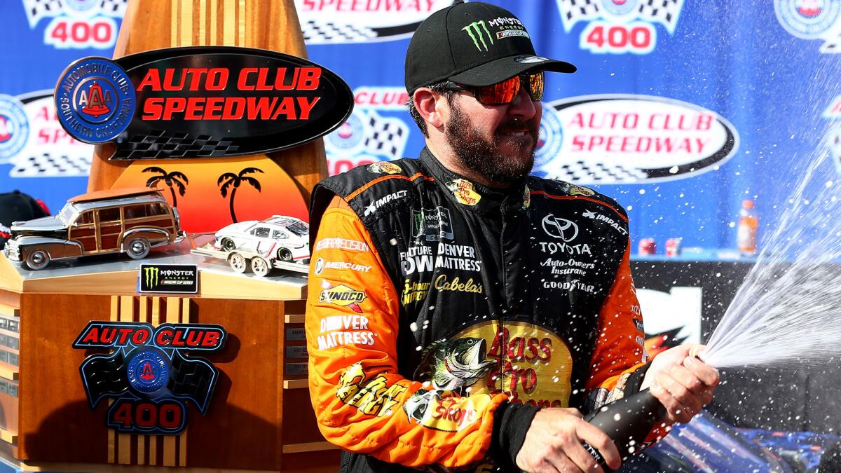 NASCAR driver Martin Truex Jr. celebrates after winning the Auto Club 400 on Sunday.